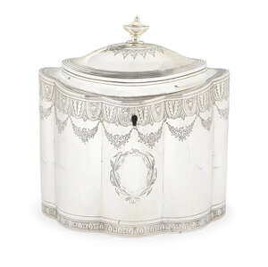 A George III tea caddy, London c.1797, Henry Chawner & John Eames, of oval lobed form, the domed hinged cover with urn finial, bright cut decoration and two va