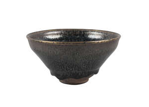 A Chinese yuteki tenmoku 'oil spot' tea bowl, Jian kilns, Fujian province, Song dynasty, the deep sides covered inside and out with a thick, black irid