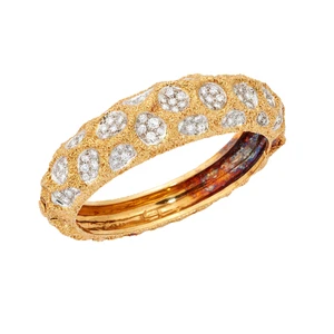 Kutchinsky. An 18ct gold diamond set hinged bangle, of textured finish, with concave pavé diamond set craters, signed, London hallmarks, 1989, inner diameter 