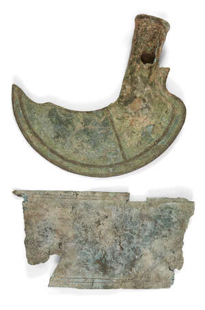 A bronze socketed sickle, Late Bronze Age, circa 1200-800 B.C., with hollow shaft, 18cm high and...
