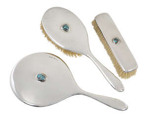 
	
		Liberty & Co (British), a silver dressing table set with turquoise matrix cabochons  ...