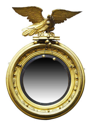 
	
		A Regency gilt framed circular wall mirror, the carved eagle crest with chain suspended...