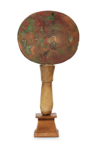 
	
		A bronze and calcite Egyptian Mirror, Middle Kingdom, 1938-1758 B.C., the disc shaped...