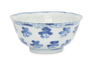 A Chinese porcelain moulded bowl, Kangxi period, painted in underglaze blue with floral sprays to each moulded panel, underglaze blue fylfot mark within a doub