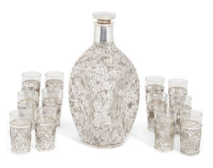 
	
		A Japanese silver mounted cherry blossom sake set, comprising a compressed glass decanter...