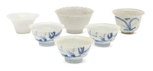 Six Chinese porcelain teabowls and a small dish, 18th - 19th century, painted in underglaze blue with landscapes and floral sprays, 9cm - 7cm diameter
		Prove