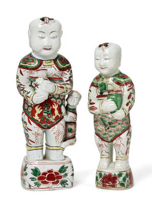 Two Chinese porcelain wucai standing figures of smiling boys, hehe, Shunzhi-period, each holding...