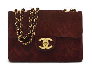 
	
		Chanel: a burgundy quilted suede flap front handbag, with long double gilt metal and...