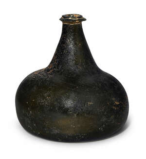 
	
		A dark green glass bottle, late 17th century,  of squat onion form, 15cm high
		