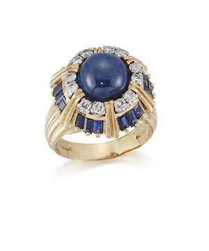 An 18ct. gold, sapphire and diamond ring, by Kutchinsky, the domed cluster set in the centre with a cabochon sapphire within claw-set circular-cut diamond surr