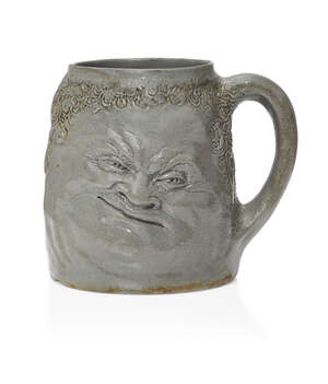 
	
		R.W. Martin (1843-1923), a Martin Brothers stoneware Double Face mug
		c.1890, Signed...