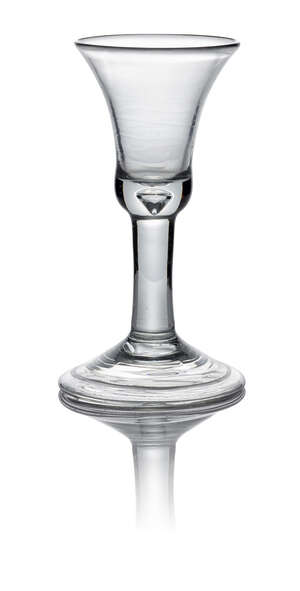 A George II plain stem wine glass, c. 1740, with bell bowl with teared heavy base above a plain stem standing on a folded conical foot, 14cm high
