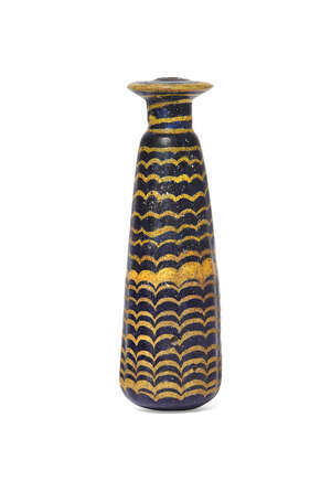 A Greek core-formed blue glass alabastron, circa 2nd-1st Century B.C., the vertical ribbed body flaring towards the rounded base, decorated with yellow combed 