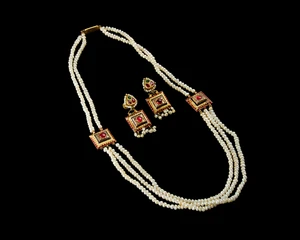 An Indian cultured pearl three strand necklace, together with matching earrings,India, 20th...