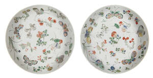 A pair of Chinese porcelain dishes, Kangxi period, painted in famille verte enamels with butterflies and floral sprays, 21.4cm diameter
		 
		Provenance: Ar
