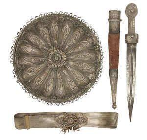 
	
		An Ottoman silver filigree circular mirror, a dagger, and a silvered filigree belt,...