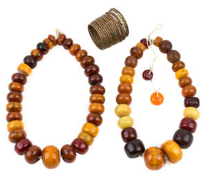 
	
		Two amber bead necklaces, 20th century, comprised of square, flattened ovoid, and...