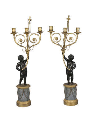 
	
		A pair of French bronze and ormolu figural three light candelabra, late 19th century, 
