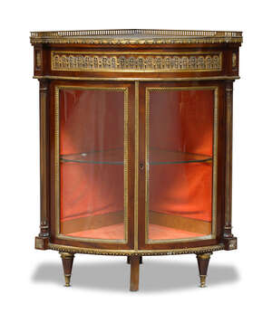 
	
		A Louis XVI style mahogany and gilt metal mounted corner vitrine, early 20th Century, of...