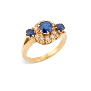 A sapphire and diamond ring, the central cluster set with a circular mixed-cut sapphire, with an old-cut diamond surround, to further sapphire set split should