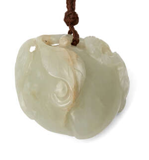 
	
		A Chinese pale green jade peach pendant, 19th century, finely carved as a bat atop a...