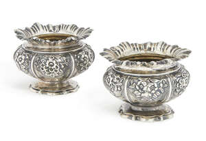 A good pair of William IV silver salts, London c.1834, James Charles Edington, of lobed circular form with flared rim, embossed with fruit and flowers, on circ