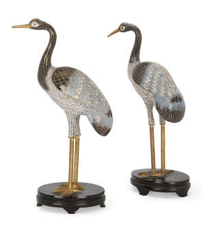 
	
		A pair of Chinese cloisonné enamel figures of storks, 20th century, on stained wood oval...