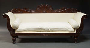 
	
		A Victorian mahogany sofa, with scroll carved back rail, and out scrolling arms,...