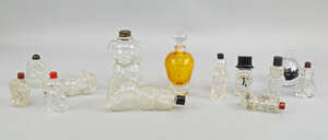 A collection of eleven clear glass character  perfume bottles, 20th century, to include figures of Felix the cat and others, together with a Sark glass perfume