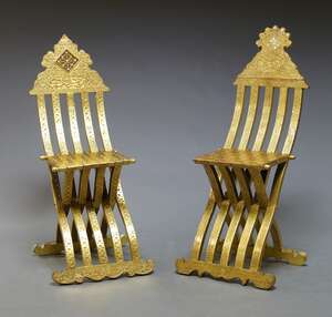 
	
		A near pair of middle Eastern gilt side chairs, 20th Century, with overall carved...