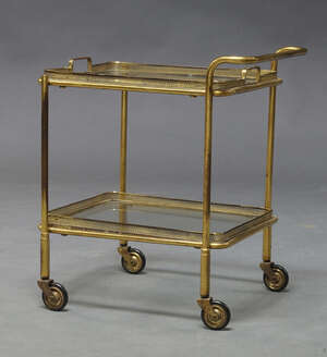 
	
		A diminutive brass and glass tea trolley, c.1950s, with two tray type tiers with pierced...