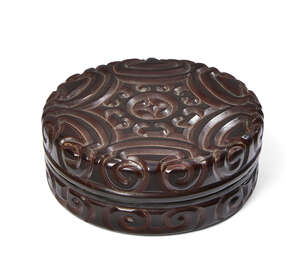 A Chinese tixi lacquer circular box and cover, Ming dynasty, 16th century, finely carved through layers of black and red lacquer with a central flowerhead moti