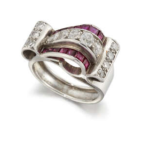 
	
		An Art Deco platinum, diamond and ruby cocktail ring, of scrolling form, set with...