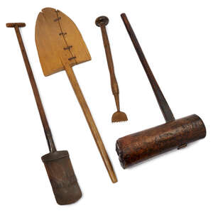 
	
		A collection of four treen tools, comprising a large pine mallet, 97cm high, an elm and...