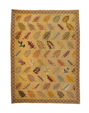 A flatweave rug, last quarter 20th century,&nbsp;with repeating oak leaf design, on a beige ground,...