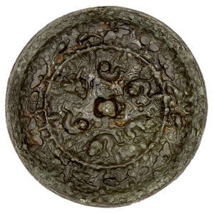 
	
		A large Chinese bronze 'lion and grapes' circular mirror, Tang dynasty, the central knob...