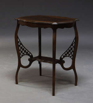 
	
		An Edwardian mahogany occasional table, the shaped top on cabriole legs, joined by...