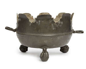 
	
		A large German pewter monteith, early 18th century, with two shaped handles, raised on...