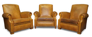 
	
		Designer Unknown, 
		 
		Three club armchairs, 20th century, 
		Tan leather, black...