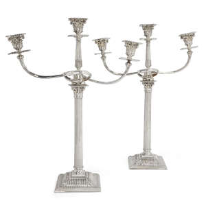 
	
		A pair of silver plated three branch candelabra, the columnar stems with acanthus...