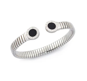 Bulgari. A stainless steel tubogas bangle, with circular terminals set with onyx, marked 'BVLGARI BVLGARI', signed, stamped Made in Italy, with box and outer c