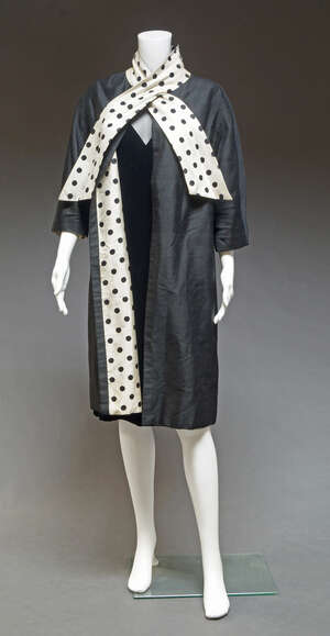 
	
		A black velvet cocktail dress, by Gina Bacconi, with net bodice and short sleeves, UK...