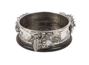 A silver coaster, London c.1985, Michael Allen Bolton, of heavy gauge, with applied vine and grapes, upon a turned wooden base, internal diameter 10.5cm