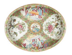 A Chinese Canton porcelain oval dish, 19th century, painted in famille rose enamels with panels...