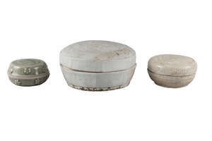 Three Chinese porcelain circular boxes and covers, comprising a Song dynasty qingbai glazed floral moulded box, 11cm diameter, a Song dynasty white-glazed flor