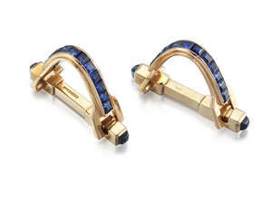 
	
		A pair of sapphire cufflinks, of hinged stirrup design set with a single row of calibré...