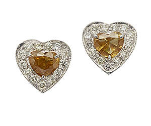 
	
		A pair of coloured diamond and diamond earstuds,  each with single claw-set heart-shaped...