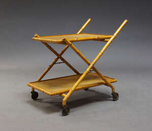 
	
		A French bamboo and rattan two tier trolley, c.1960,
		with folding bamboo x-shaped...