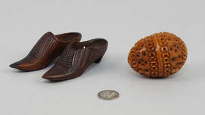 
	
		A coquilla nut oval form pierced  box, 19th century, together with a silver 1918 coin, ...