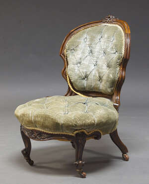 
	
		A Victorian mahogany nursing chair, the frame with carved foliate decoration, having...